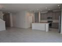 Open-concept living room with tile floors and views of the kitchen at 2059 Town Pasture Dr, Eustis, FL 32726