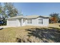 Gray house with a single-car garage and a spacious yard at 441 Danube Dr, Kissimmee, FL 34759