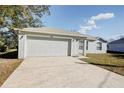 Front view of a single story house with a garage at 441 Danube Dr, Kissimmee, FL 34759
