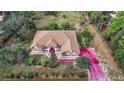 House with brown roof, large backyard, and wooded surroundings at 6900 Sw 137Th Court Rd, Ocala, FL 34481