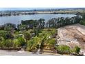 Elevated shot of property near lake and city with construction site and concrete culverts nearby at 11326 Westwood Blvd, Orlando, FL 32821