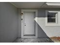 White front door entry with light fixture and doorbell at 1236 Merritt St, Altamonte Springs, FL 32701