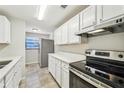 Modern white kitchen with stainless steel appliances and quartz countertops at 1236 Merritt St, Altamonte Springs, FL 32701