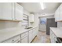 White kitchen cabinets, stainless steel appliances, and quartz countertops at 1236 Merritt St, Altamonte Springs, FL 32701