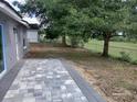 Outdoor patio area perfect for entertaining or relaxing, overlooking a spacious backyard with lush greenery at 15613 Greater Groves Blvd, Clermont, FL 34714