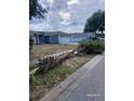 Street view of a well-maintained home with a tidy yard and driveway, showcasing neighborhood charm at 15613 Greater Groves Blvd, Clermont, FL 34714