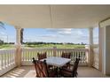 Covered balcony with table and chairs overlooking the golf course at 1364 Centre Court Ridge Dr # 201, Reunion, FL 34747