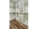 Bright walk-in closet featuring custom shelving, drawers, and ample storage space at 350 Marion Oaks Pass, Ocala, FL 34473