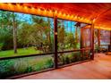 Relaxing screened porch overlooking a lush backyard at 6408 Shoreline Ct, St Cloud, FL 34771