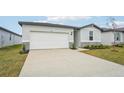 Front view of a one-story house with a two-car garage at 2125 Rosewood Dr, Bartow, FL 33830