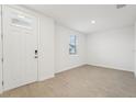 Bright foyer with wood-look tile floor and white walls at 2137 Rosewood Dr, Bartow, FL 33830