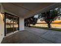 Covered patio overlooking a serene lake at sunset at 1704 Ison Ln, Ocoee, FL 34761