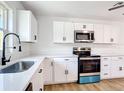 Modern kitchen featuring white cabinets, stainless steel appliances, and quartz countertops at 4317 Ne 12Th St, Ocala, FL 34470