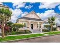 Charming two-story home with a welcoming front porch, landscaped yard, and picturesque curb appeal at 5342 Horton Ln, Orlando, FL 32814