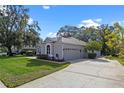 A view of the house with a 2-car garage and side yard at 571 Masalo Pl, Lake Mary, FL 32746