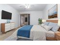 Bright bedroom with a large bed, white walls, and a sliding door to the outside at 104 Coventry Ln, Haines City, FL 33844