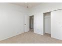Carpeted bedroom featuring an open closet, ceiling fan, and neutral walls at 14216 Boca Key Dr, Orlando, FL 32824