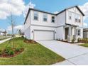 Inviting two-story home with a well-manicured lawn and a two-car garage on a clear, sunny day at 339 Conway Ave, St Cloud, FL 34771
