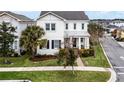 Charming two-story home with a well-manicured lawn, and covered front porch at 9133 Smithies St, Orlando, FL 32827