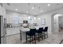 Modern kitchen featuring granite countertops, stainless steel appliances, and a center island at 9133 Smithies St, Orlando, FL 32827