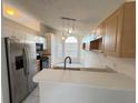Kitchen boasts stainless steel appliances and light wood cabinets at 147 Dahlia Village Cir # Ge, Orlando, FL 32807