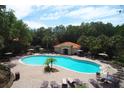 Community pool with lounge chairs and a pool house at 5149 Adelaide Dr, Kissimmee, FL 34746
