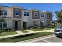 Two-story townhome with neutral siding and landscaping at 2334 Zaballina Pl, Kissimmee, FL 34747