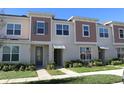 Two story townhome with neutral siding and landscaping at 2334 Zaballina Pl, Kissimmee, FL 34747