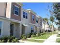 Row of two-story townhomes with neutral siding at 2334 Zaballina Pl, Kissimmee, FL 34747