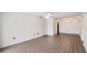 Bright living room with wood-look floors flowing into tiled dining area, adjacent to a door and closet at 314 Cherokee Ct # H, Altamonte Springs, FL 32701