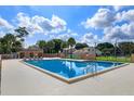 Sparkling community pool surrounded by lounge chairs and lush landscaping at 3377 Hamlet Loop, Winter Park, FL 32792