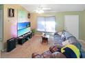 Bright living room featuring a large TV and comfortable seating at 704 Monroe Harbor Pl, Sanford, FL 32773