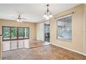 Bright dining room with hardwood floors, sliding glass doors, and a view of the backyard at 13632 Paytons Way, Orlando, FL 32828