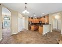 Open kitchen with an island and views into the adjacent dining area at 13632 Paytons Way, Orlando, FL 32828