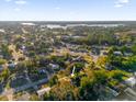 Aerial view of a home nestled in a lush, green neighborhood near a lake at 2341 Hadley St, Deltona, FL 32738