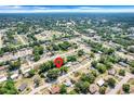Expansive aerial view of a residential neighborhood with mature trees and clear blue skies at 2341 Hadley St, Deltona, FL 32738