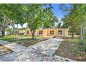 A quaint single-Gathering home featuring a simple design and a spacious driveway for easy parking at 2341 Hadley St, Deltona, FL 32738