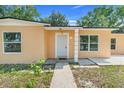 Inviting entrance featuring a classic white front door with decorative columns and manicured landscaping at 2341 Hadley St, Deltona, FL 32738