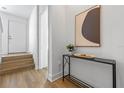 Bright entryway with stairs, console table, and art at 66 W Harding St # B, Orlando, FL 32806