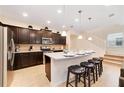 Modern kitchen with dark cabinets, stainless steel appliances and an island at 8851 Geneve Ct, Kissimmee, FL 34747