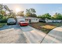 Newly renovated home with a driveway and a spacious front yard at 1307 Pine Lake Rd, Orlando, FL 32808
