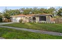 House exterior showcasing a well-maintained lawn and attached garage at 1422 Tierra Cir, Winter Park, FL 32792