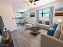 Open-concept living room featuring wood floors, neutral walls, updated furnishings in a staged setting at 19942 Se 155Th Pl, Umatilla, FL 32784