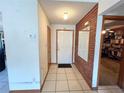 Inviting entryway with tile flooring, brick accent wall, and mirrored feature at 2708 Sedgefield Avenue, Deltona, FL 32725