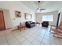 Bright living room featuring tiled floors and comfy seating at 2708 Sedgefield Avenue, Deltona, FL 32725
