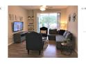 Living room featuring a sectional sofa and flat-screen TV at 8817 Dunes Ct # 203, Kissimmee, FL 34747