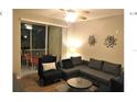 Spacious living room with sectional sofa and balcony access at 8817 Dunes Ct # 203, Kissimmee, FL 34747