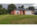 One-story house with a white garage door and green lawn at 1009 Fort Smith Blvd, Deltona, FL 32725
