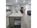 Modern kitchen with island, stainless steel appliances, and white cabinets at 1009 Fort Smith Blvd, Deltona, FL 32725