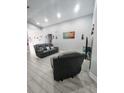 Living room with gray recliner chairs and wood-look flooring at 1009 Fort Smith Blvd, Deltona, FL 32725